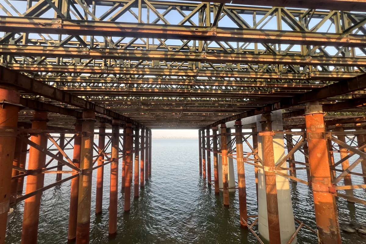 Underside of a bridge trestle: pipe piles, cross bracing and Bailey trusses over water
